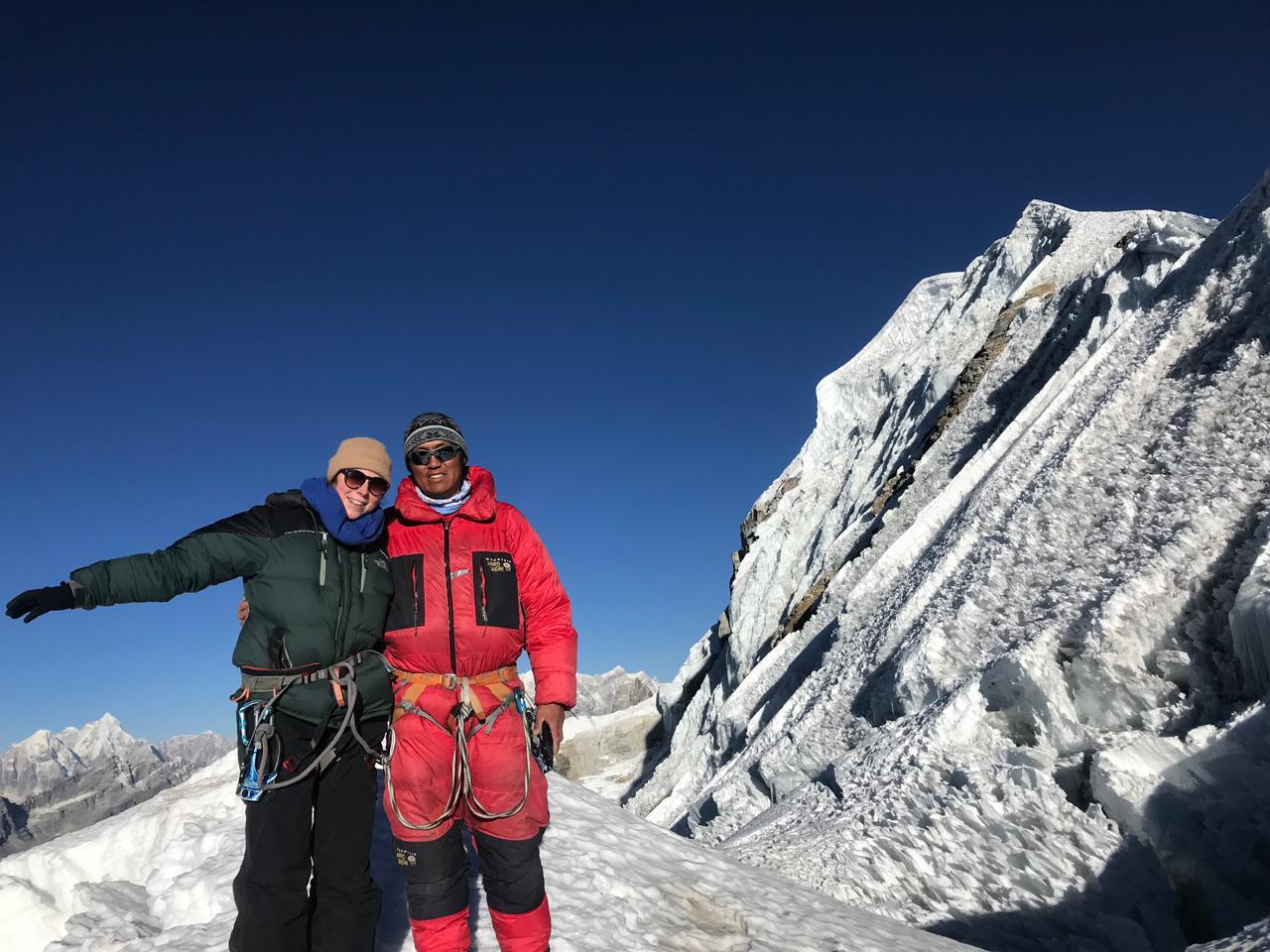 Climbers on Lobuche Peak beside a snowy ridge